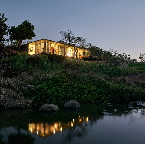 Architecture Brio designs a house on the water's edge rising over the ghats