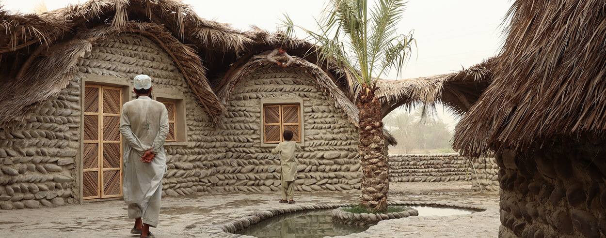 A network of palm trusses and a double-layered roof define a guesthouse in rural Iran A network of palm trusses and a double-layered roof define a guesthouse in rural Iran