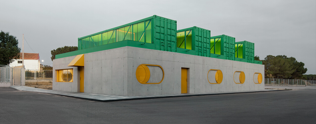 Concrete and shipping containers stack up in lego-like forms in Agrosemillas Offices Concrete and shipping containers stack up in lego-like forms in Agrosemillas Offices