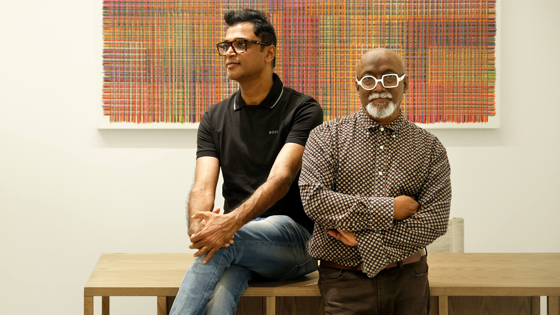 Sreejith Pathangalil and Bose Krishnamachari standing in front of a painting by Harisha Chennangod | DTale Archist | STIRworld
