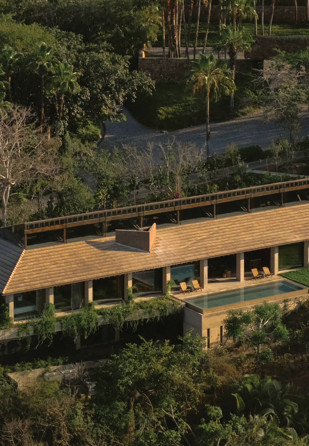 An aerial view of The Kupuri House, nestled in Punta Mita, showcases the seamless integration of the residence with its lush, natural surroundings and the Pacific Ocean | The Kupuri House | Modica Led