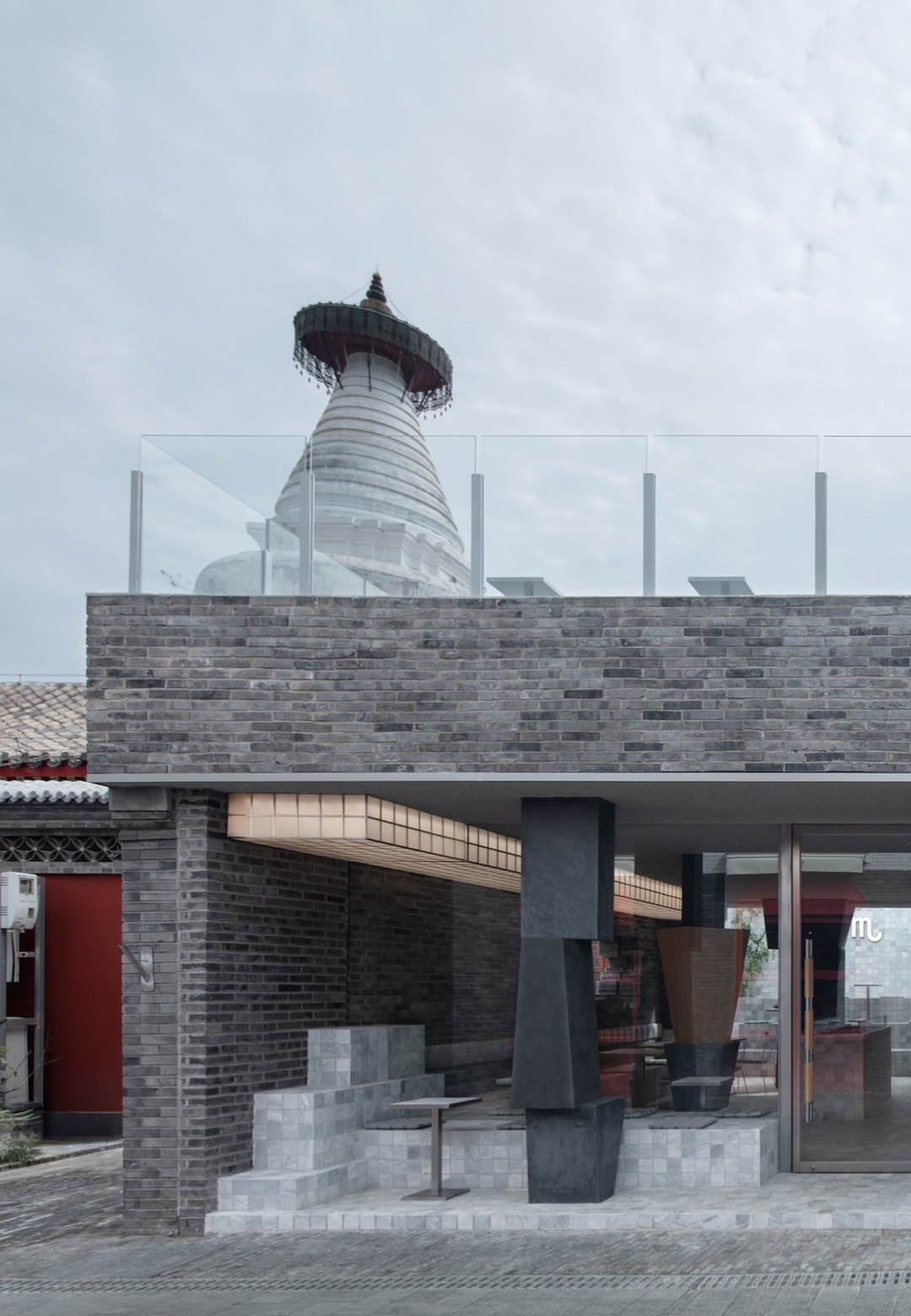 Renovated by B.L.U.E. Architecture Studio, the JM Cafe and bakery shop establishes a dialogue with the ancient White Pagoda Temple and a public square | JM Cafe | B.L.U.E. Architecture Studio | STIRwo