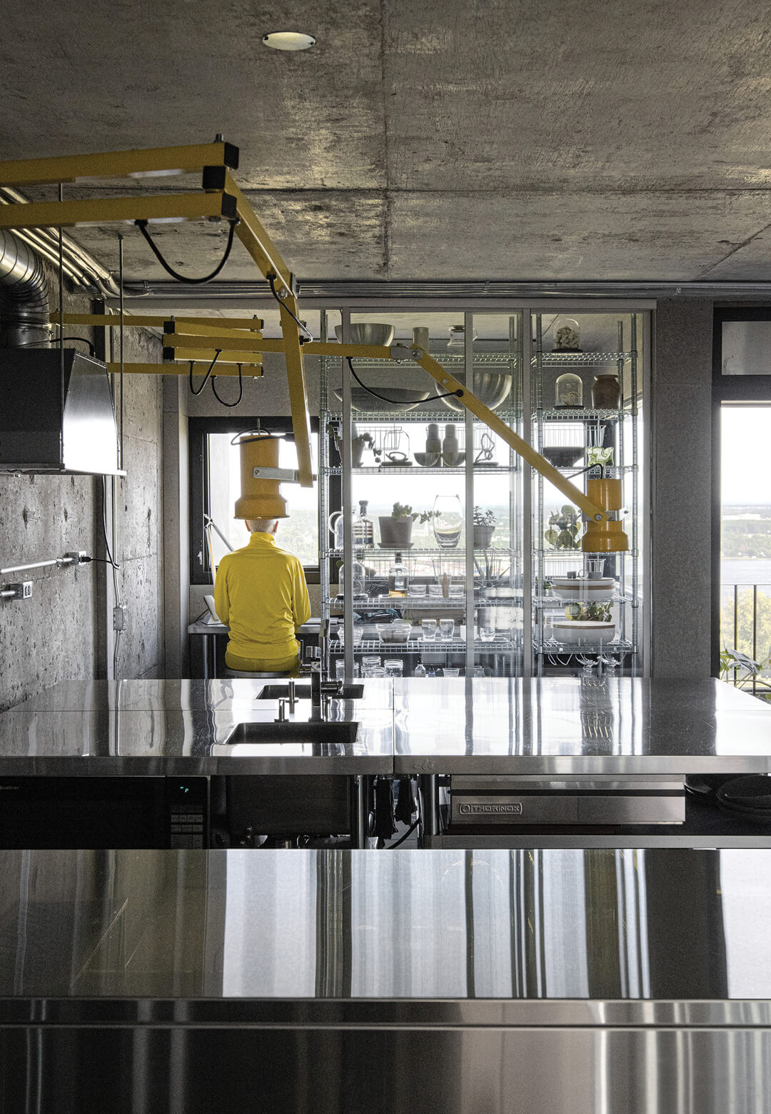 Industrial furnishings complement the brutalist shell of the apartment that captures views of Québec City | BRUJ cabinet de curiosités by Jean Verville | STIRworld