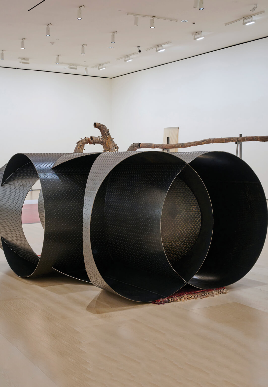 ‘Vascular (5)’, curved checker steel plate and rugs, 2024, June Crespo | STIRworld
