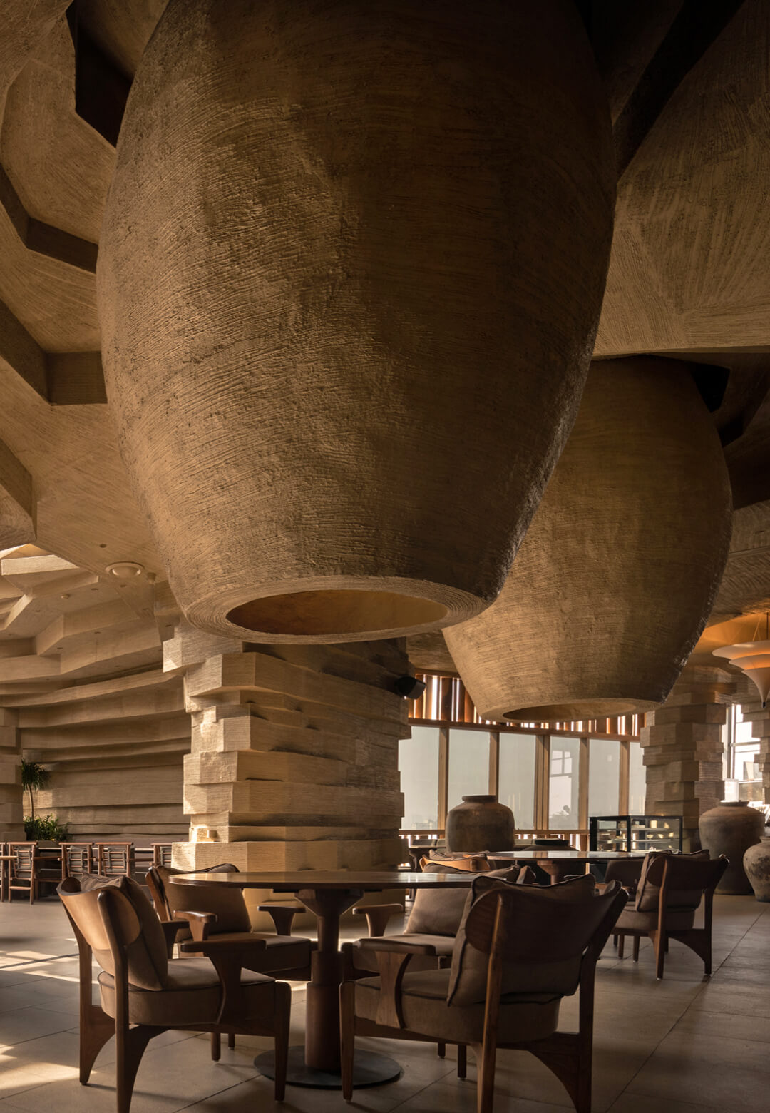 Evoking excavated architecture, the interior at Mocha Pune recalls spaces carved from earth, shaped by mass, shadow and stratified form | Mocha | Loop Design Studio | STIRworld