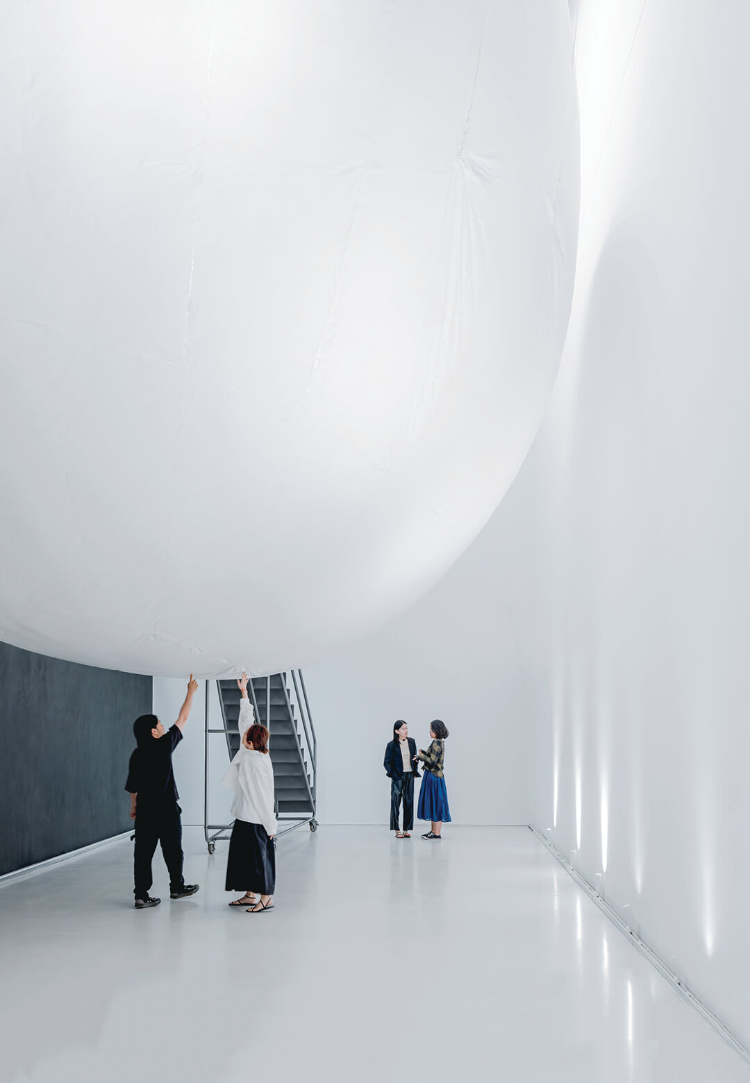 The Matrix manifests as a white, inflatable, ellipsoidal cabin suspended from the gallery's ceiling; (R) Inside, the visitors interacts with the soft, semi-transparent membrane| Matrix | STIRworld