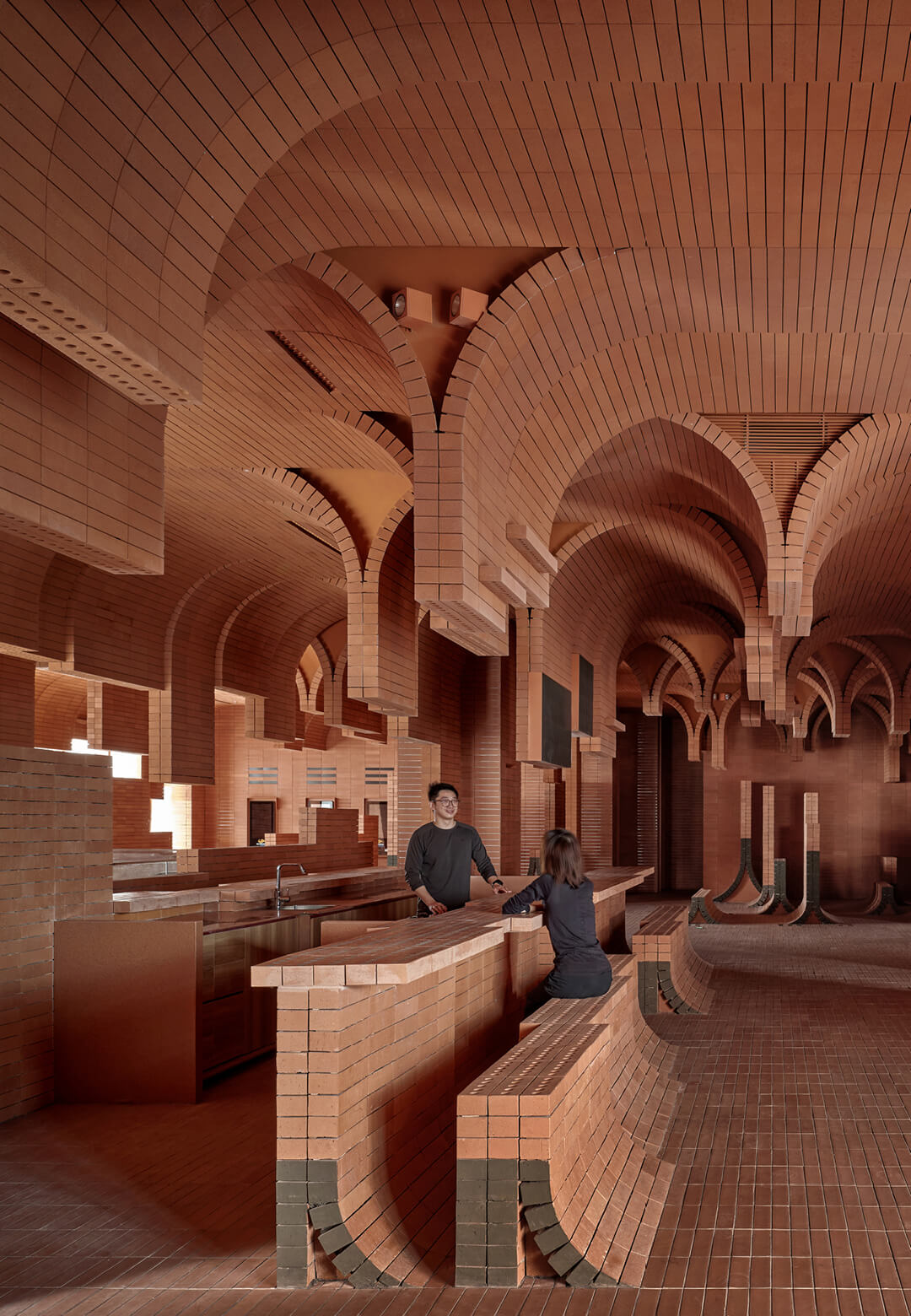 One Plus Partnership mimics sea waves inside the Haikou Gaoxingli Insun Cinema and Coffee Bar through flowing, layered bricks | Haikou Gaoxingli Insun Cinema and Coffee Bar | One Plus Partnership