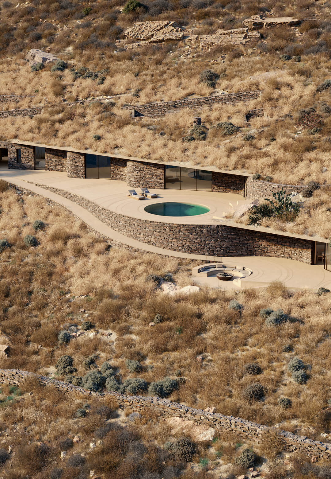 The Greek residence seamlessly blends with the rugged landscape, featuring natural stone walls and a minimalist design that echoes the terrain | Rhoēs Villa | Sinas Architects | STIRworld