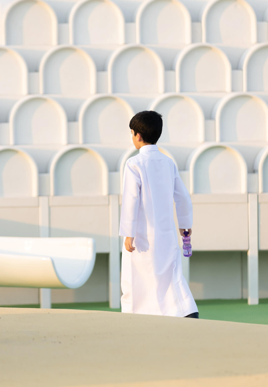 Child in front of one of the structures of Doha Modern Playground at Al Masrah Park in Doha, Qatar, 2022, Shezad Dawood | Doha Modern Playground | Shezad Dawood | STIRworld