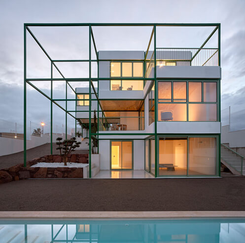 Green steel grid embraces the Brick Vault House by Space Popular in Valencia, Spain
