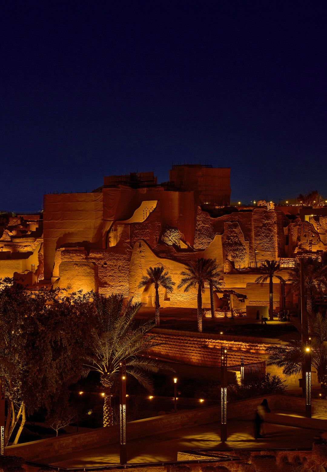 The layers of ancient mudbrick structures, streets and courtyards are revealed in soft rose-gold light | At-Turaif | Speirs Major Light Architecture | STIRworld
