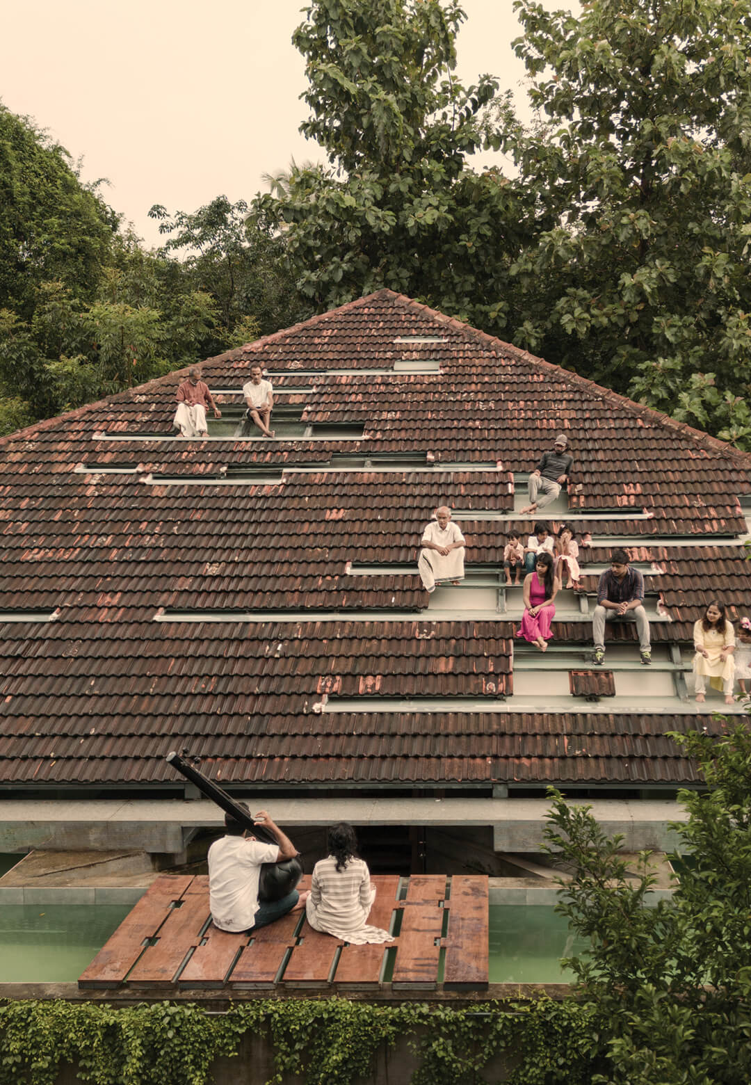 This atypical Keralite tiled roof has the added functionality of being seating for concerts held at the swimming pool | Nisarga Art Hub | Wallmakers | STIRworld