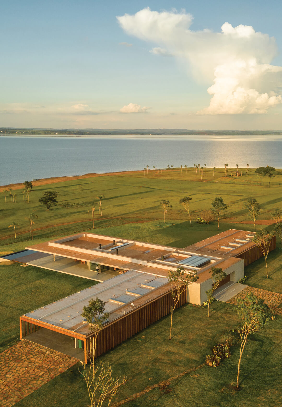 The pavilion-like design integrates seamlessly into the lush landscape near Jurumirim Dam, showcasing mf+arquitetos’ vision of architectural harmony | Casa PZ by mf+arquitects | STIRworld