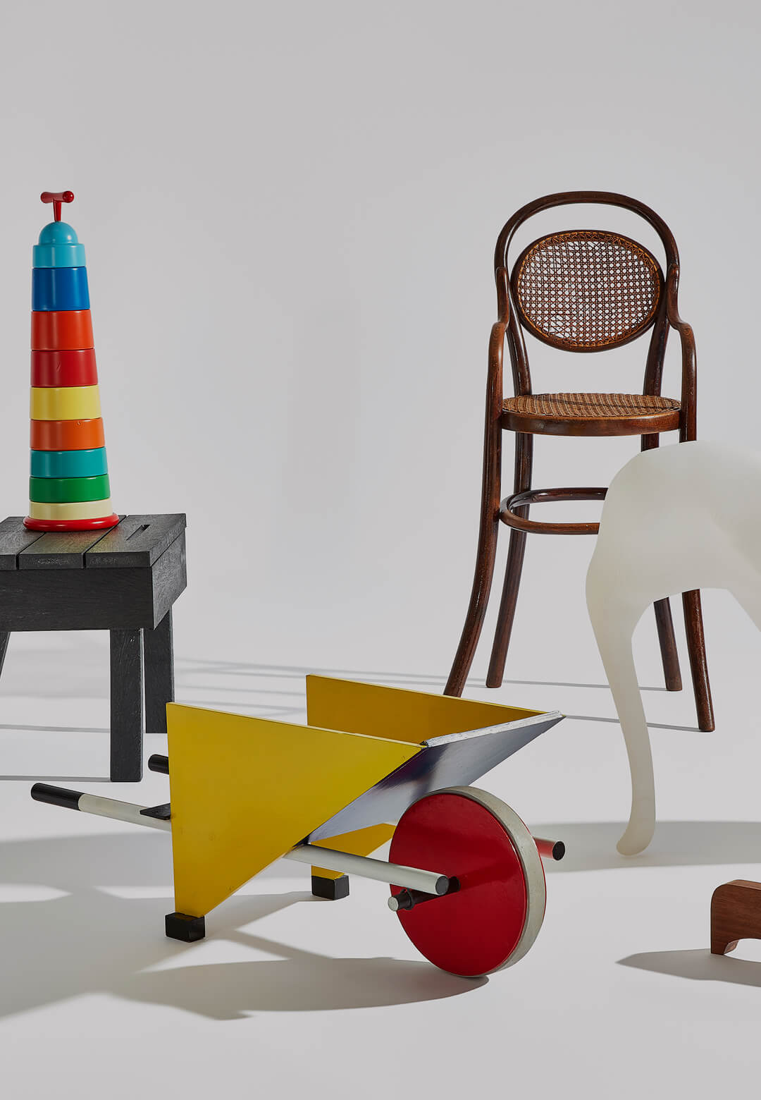 Clockwise: Michael Thonet’s highchair, Richard Hutten’s Low-res Elephant, Enzo Mari’s puzzle 16 animali, Gerrit Rietveld’s child’s wheelbarrow, Ineke Hans’s Office Desk and Chair and Torre di Mosto’s  Magis Post-Computer | STIRworld