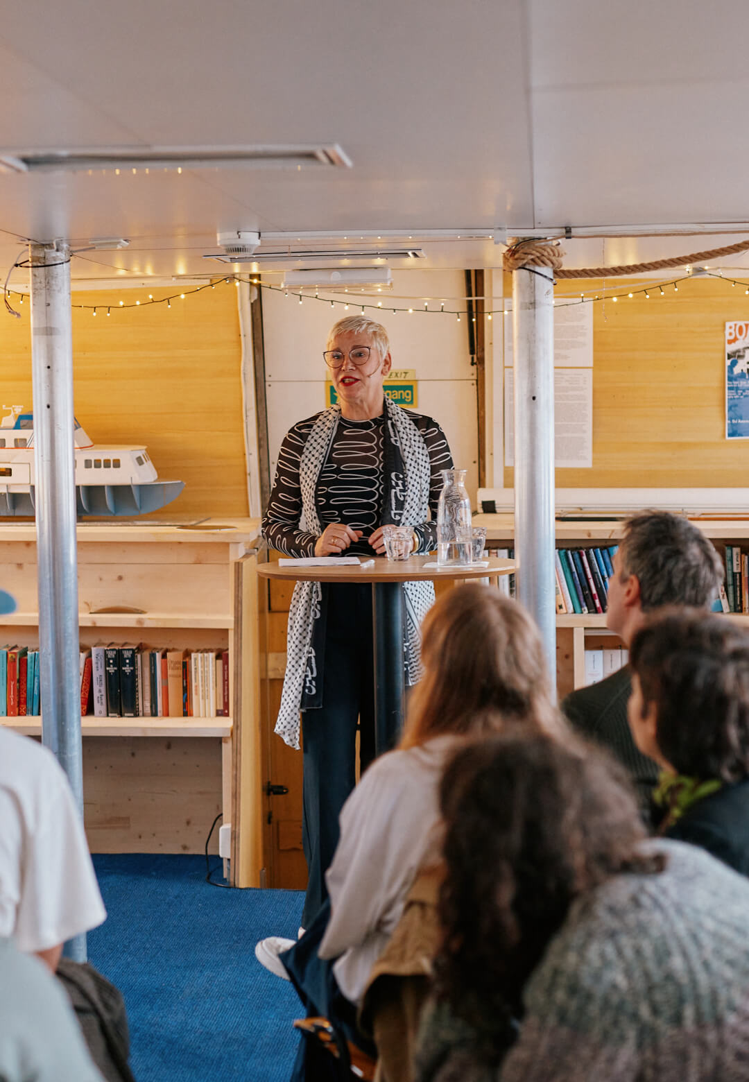 Alt Text: A &lsquo;Blocknotes&rsquo; reading by Christine Otten aboard the Literature Boat Epos as part of &lsquo;across, with, nearby&rsquo;, Bergen Assembly 2025|Bergen Assembly 2025|STIRworld