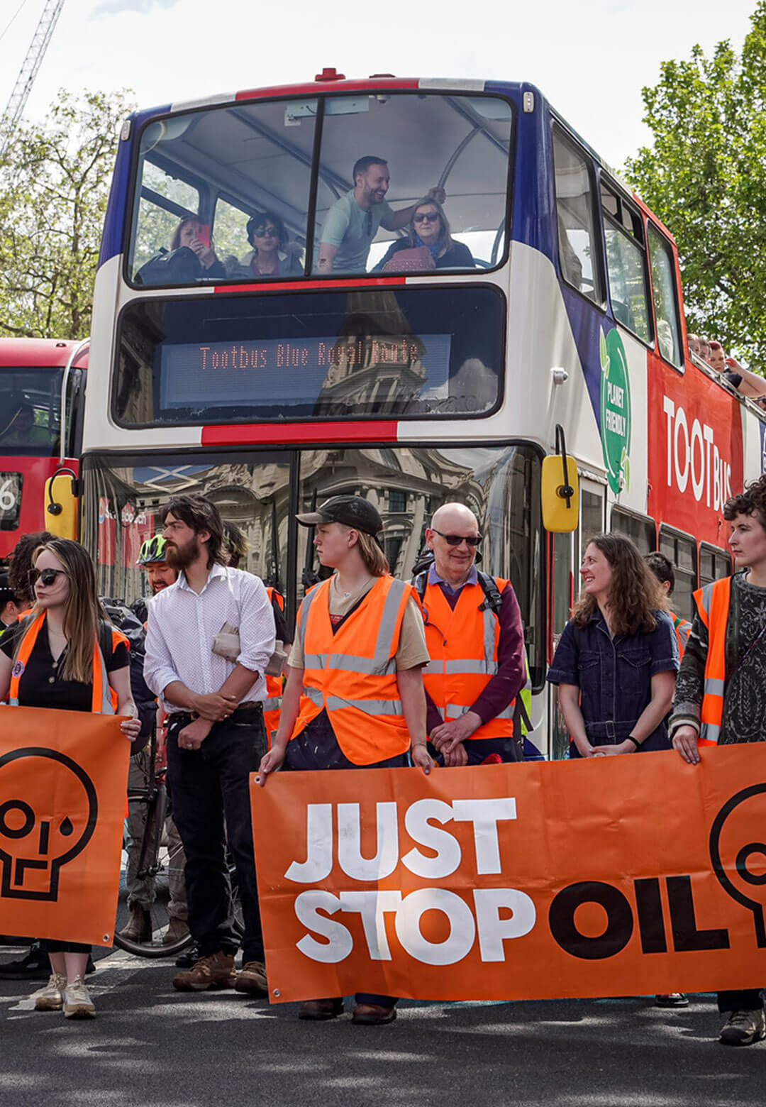 :  Just Stop Oil Activists Walking Up Whitehall on May 20, 2023 | Orange colour of protest| STIRworld