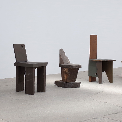 Carsten in der Elst props cragged fossilised rocks to build monolithic chairs